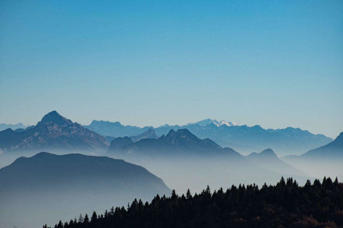 Foggy mountain range near the forest
