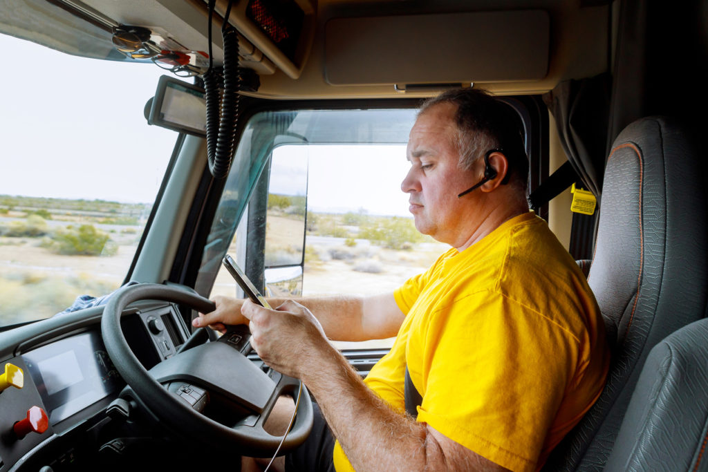A truck driver using a mobile phone while driving
